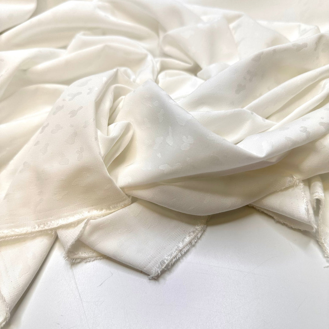 Snow Leopard In Hiding - Polyester Blend Woven - White Animal Print - Bundles - True Deadstock fabric Fabric by private - Sustainable Textile | FABCYCLE