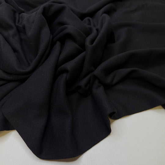 Taking Family Photos - Tubular Rib Knit Cotton Blend Knit - Black - 1.2M Bundle - True Deadstock fabric Fabric by private - Sustainable Textile | FABCYCLE